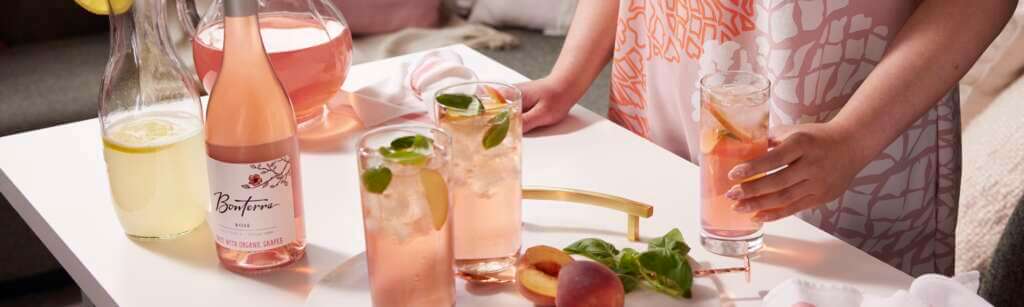 Lifestyle shot of Bonterra Rose wine with lemonade peach cocktails