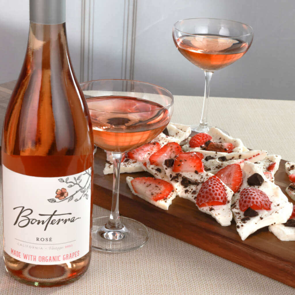 Bonterra Rosé wine with yogurt bark candy, two glass of wine in the middle.