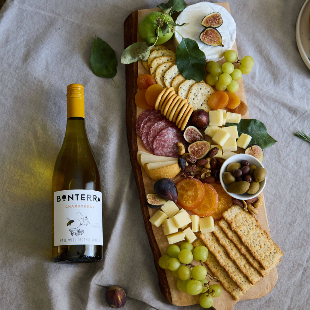 Herbed crackers and cured salami are balanced by olives and sharp cheddar in this crowd-pleasing classic grazing board.