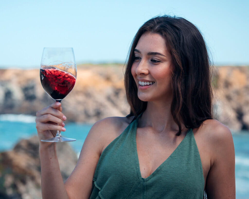 woman holding a glass of red wine